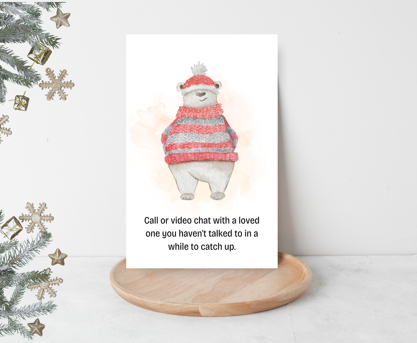 Christmas activity card with a polar bear in a sweater and hat on a stand, surrounded by Christmas decorations.
